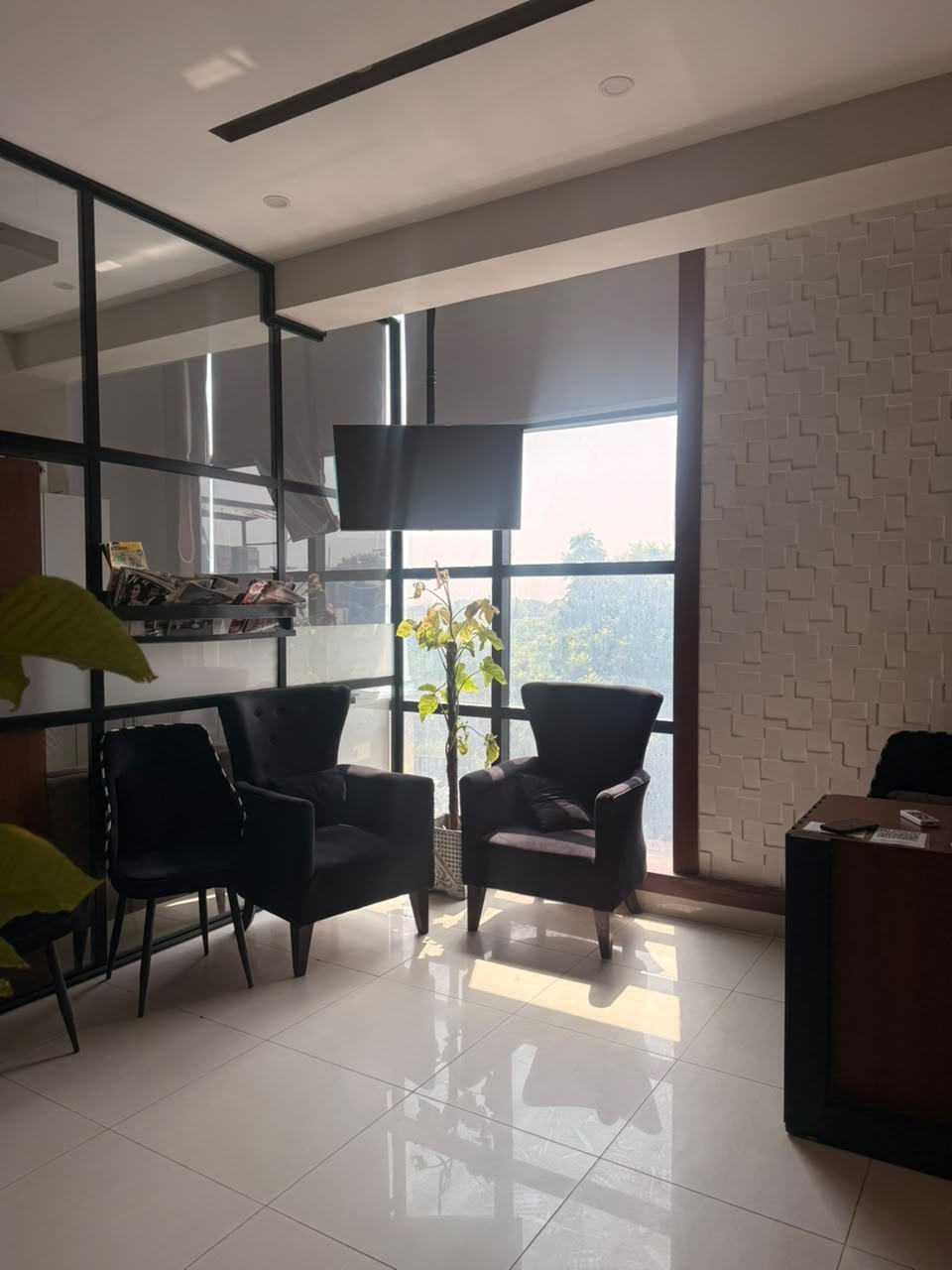 Waiting seating by the window at M M Dental Associates